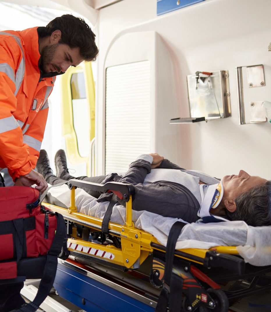 EMT-administering-aid-to-injured-truck-driver