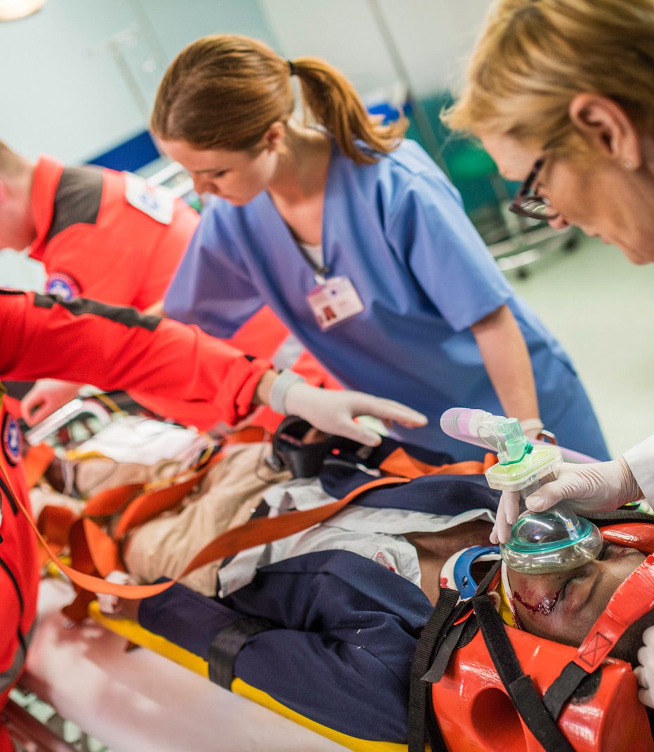 Paramedics-and-EMT-team-administering-aid-to-truck-collision-victim-with-common-injuries