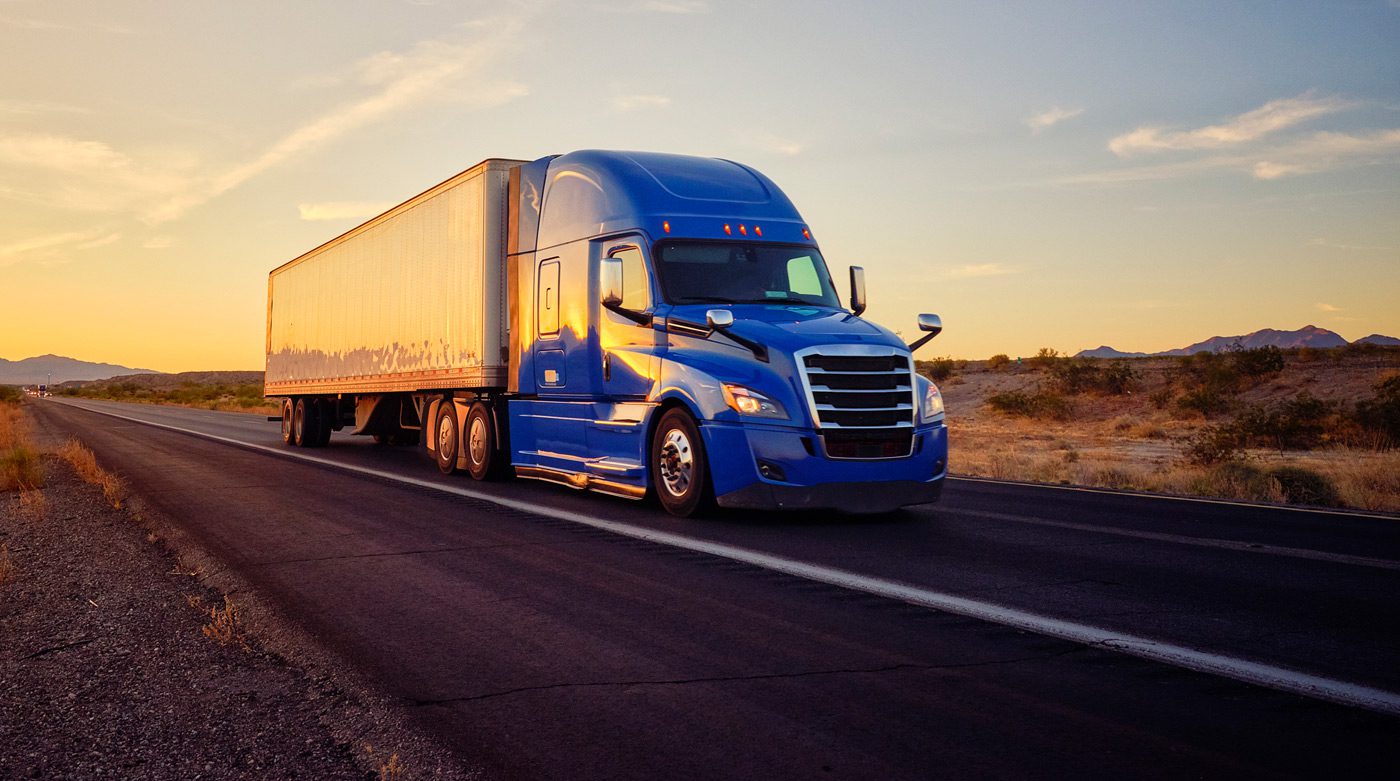 Semi-truck-on-a-highway-near-sunset