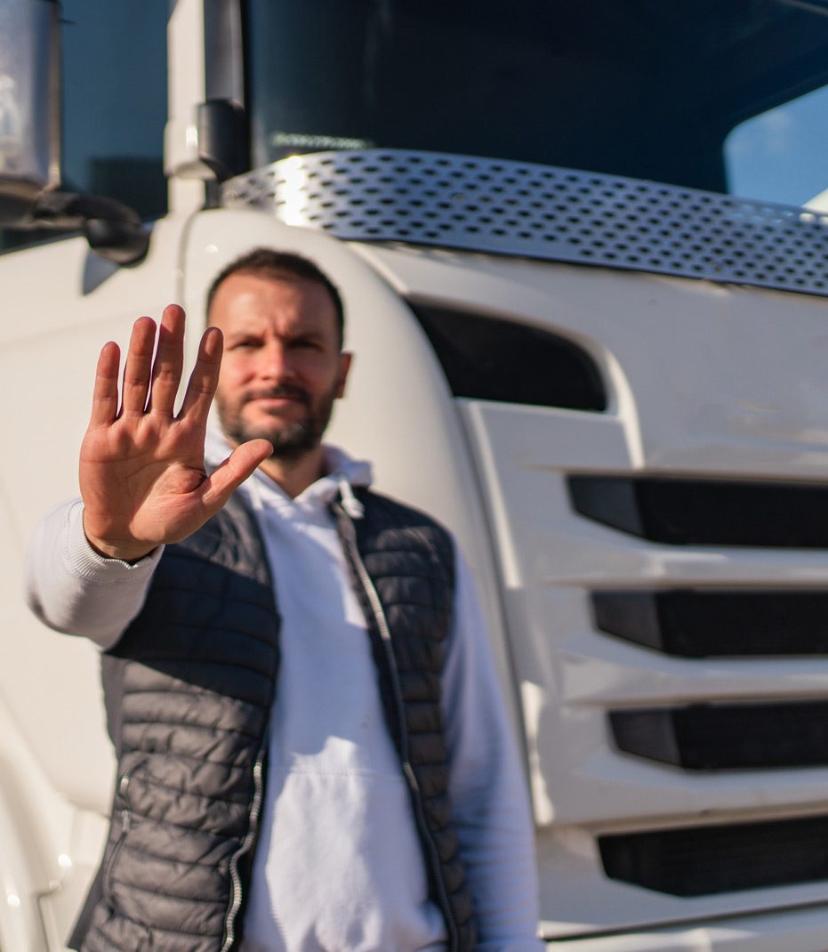 Truck-driver-standing-against-traffic-violations
