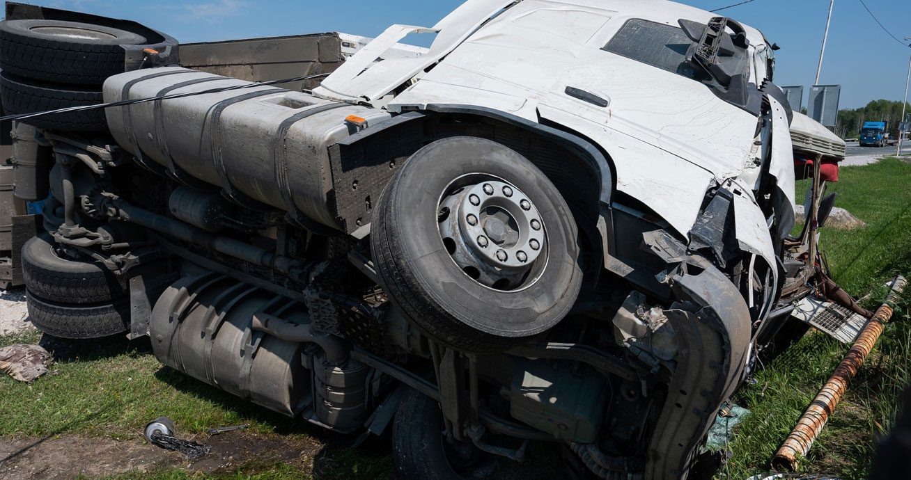 Overturned-semi-truck-lying-on-side-on-highway-roadway