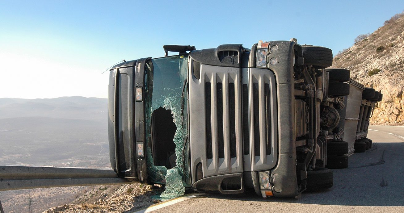 Overturned-truck-on-roadside-with-shattered-windshield
