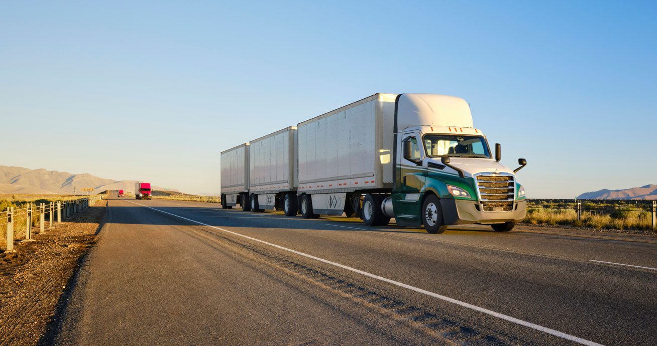 Semi-truck-with-two-trailers-driving-on-open-highway