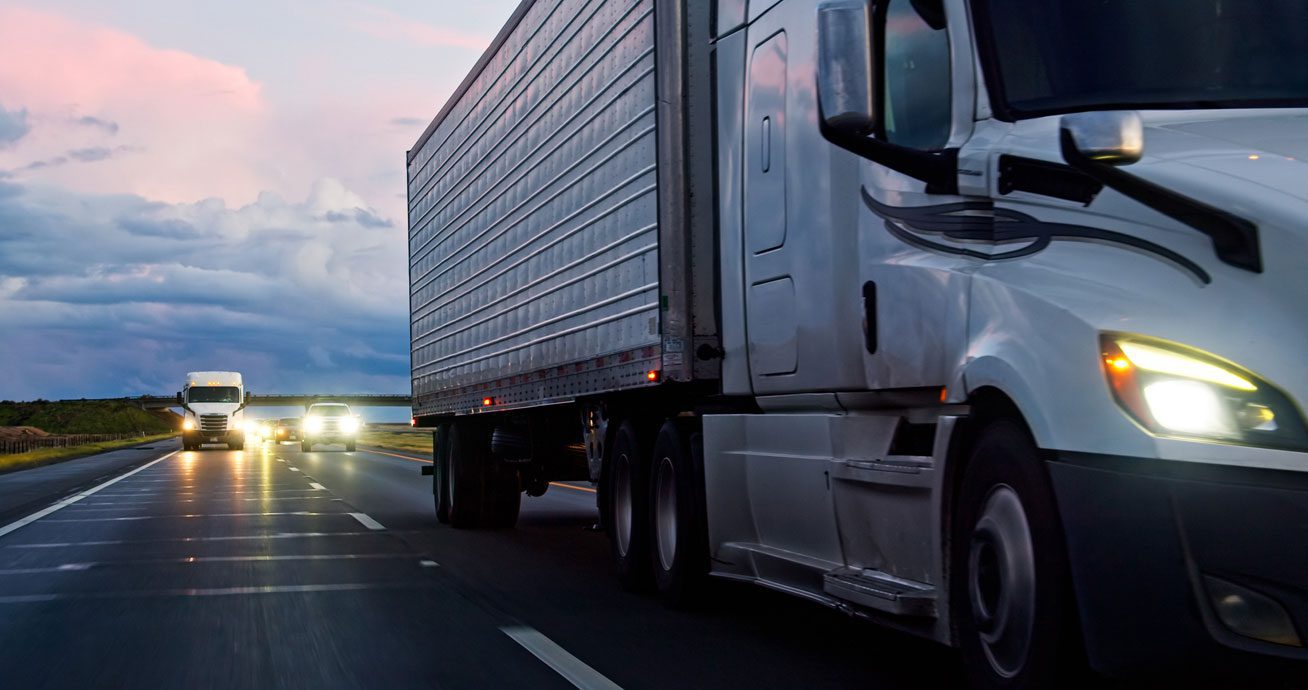 View-from-inside-car-of-semi-truck-passing-on-highway