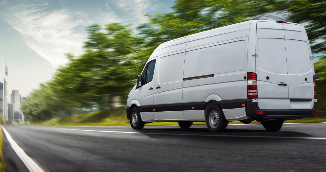 White-van-driving-on-road-in-motion