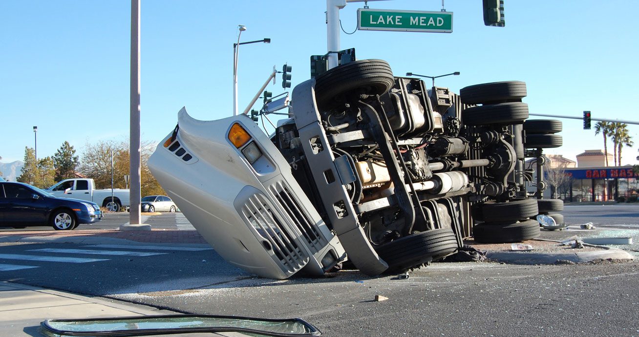 Truck-overturned-on-its-side-across-roadway