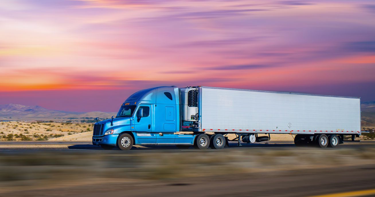 Two-semi-trucks-driving-side-by-side-on-highway
