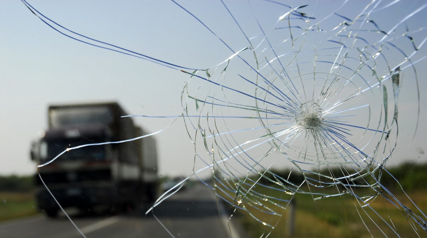 view of broken windshield from inside car on freeway
